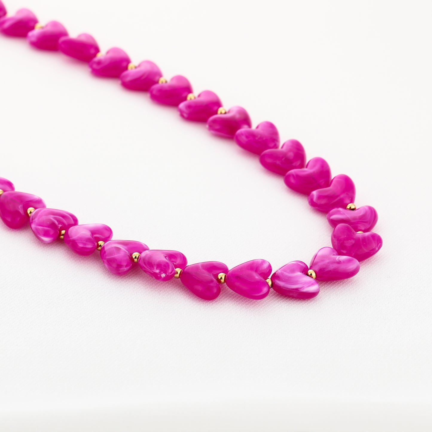 Kralenketting in hartjesvorm | Goud & Fuchsia