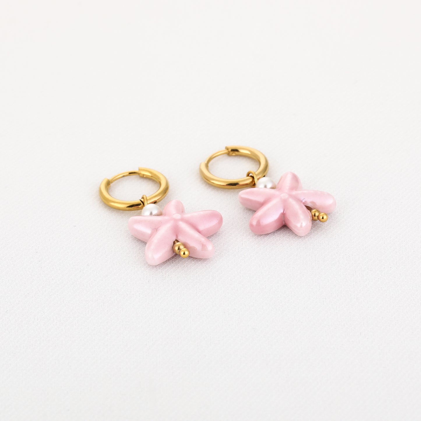 Oorbellen met roze zeester | Goudkleurig