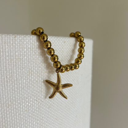 Kralenarmband met zeester | Goudkleurig