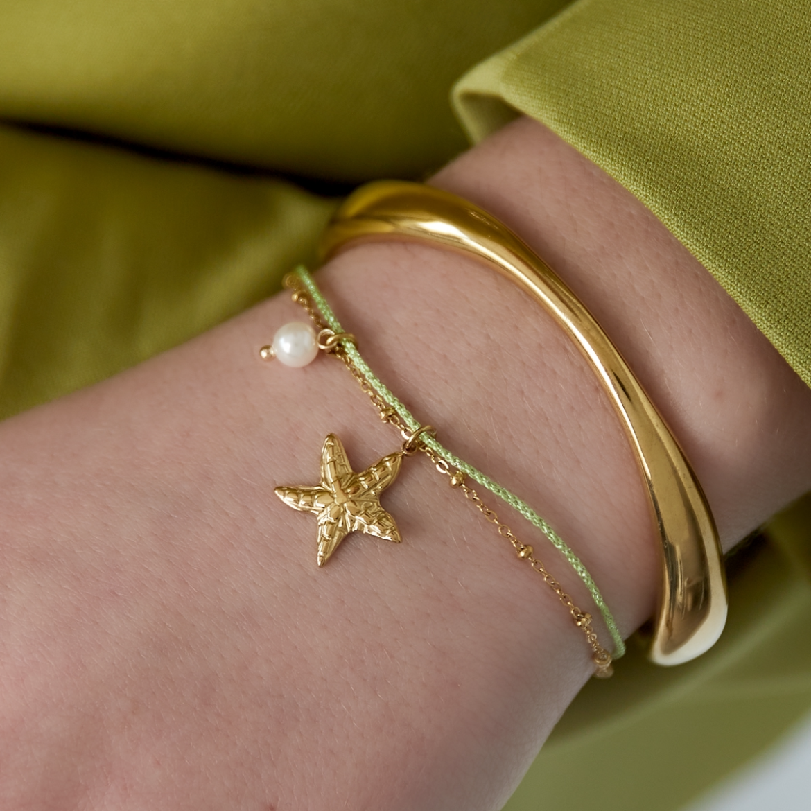 Armband met zeester en pareltje | Goudkleurig